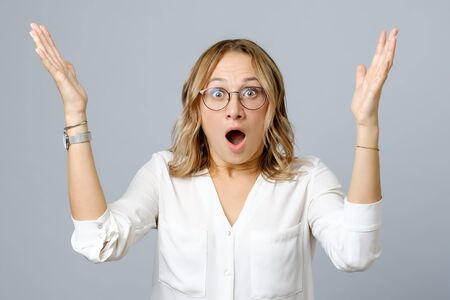 Image of excited young woman isolated over gray background