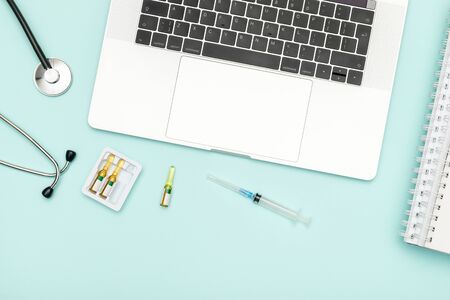 Modern medicine workplace with laptop at doctor's desk. Copy space, view from the topの写真素材