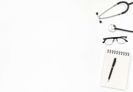 Workplace of doctor with notebook and stethoscope on colored table. Top view