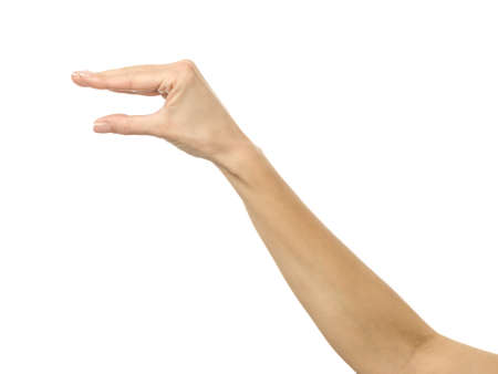 Hand picking, holding, grabbing or reaching. Woman hand with french manicure gesturing isolated on white background. Part of seriesの写真素材