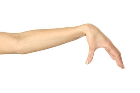 Hand picking, holding, grabbing or reaching. Woman hand with french manicure gesturing isolated on white background. Part of seriesの写真素材