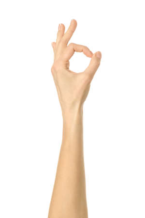 Ok sign. Woman hand with french manicure gesturing isolated on white background. Part of seriesの写真素材