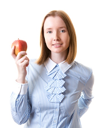 Young woman in formal wear holding apple in her hand, isolated on whiteの写真素材