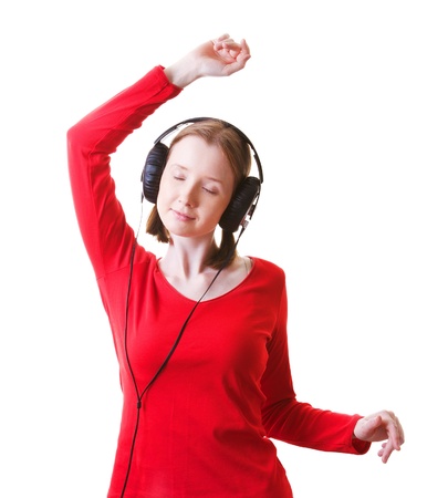 Young woman in headphones dancing, isolated on whiteの写真素材