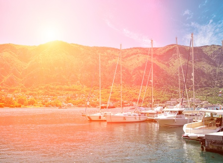 Yachts on sunset at the berth, with mountains on the backgroundの写真素材