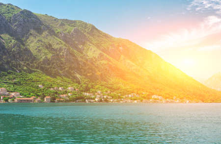 Sunset on the sea shore with mountains around