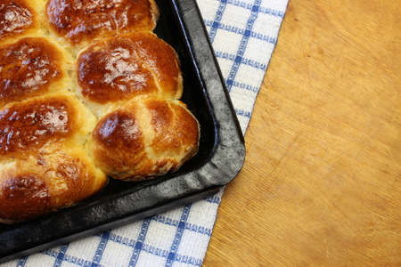 Butter ruddy pies on a baking sheet on the boardの写真素材