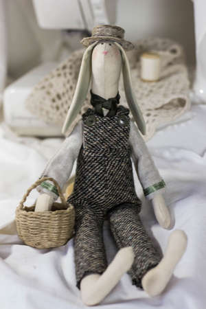 Handmade dolls. Tilda beautiful elegant. Hare with a basket and hatの写真素材
