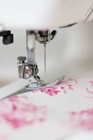 Foot sewing machine with a needle and clothの写真素材