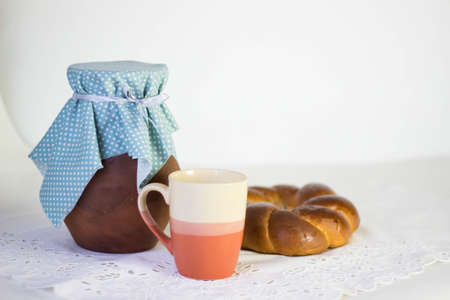 Brown clay jug and a roll and a cupの写真素材