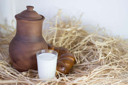 Brown clay jug and bum and cup of dry grassの写真素材