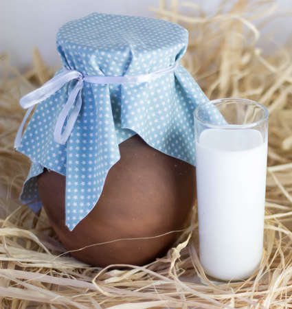 Brown clay jug and cup of dry grassの写真素材