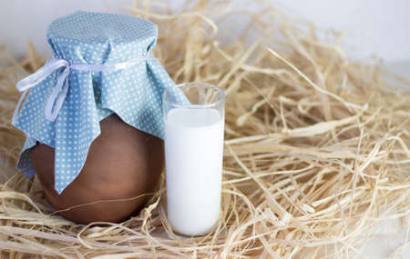 Brown clay jug and cup of dry grassの写真素材