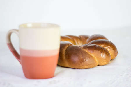 Clay cup with a muffin on a white backgroundの写真素材