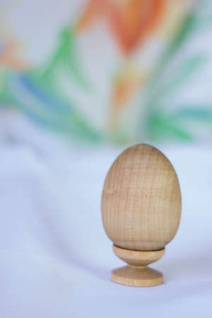 Wooden egg on stand on the cloth.Easter egg.の写真素材