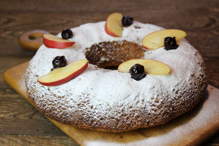 Round pumpkin pie on a wooden boardの写真素材