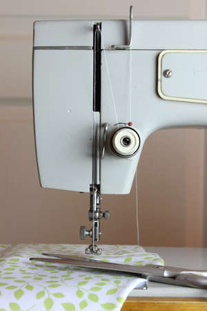 Foot sewing machine with a needle and cloth.Scissors.の写真素材