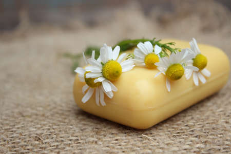 Natural soap with a camomile on a background of burlapの写真素材