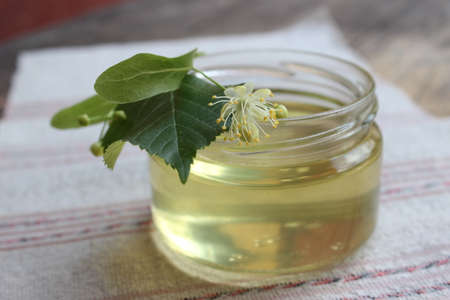 Linden flower and bee natural lime honey in a jarの写真素材