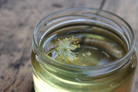 Linden flower and bee natural lime honey in a jarの写真素材