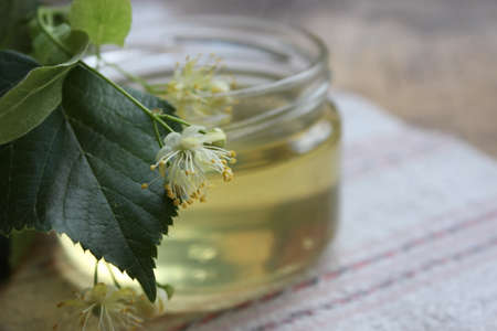 Linden flower and bee natural lime honey in a jarの写真素材