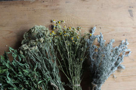 Binding of different dry herbs on wooden boards.の写真素材