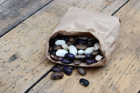 Large multi-colored bean in paper bag on background of boardsの写真素材