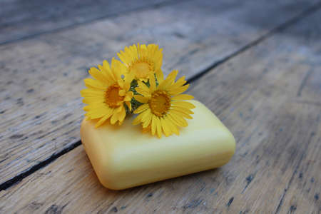 Natural soap with a camomile on a background of burlap