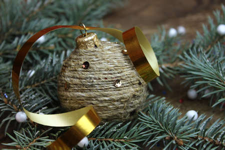 Sprig of Christmas trees and toy wrapped with twineの写真素材