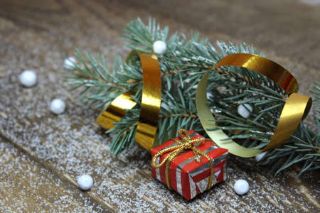 Gift and Christmas tree on wooden boards