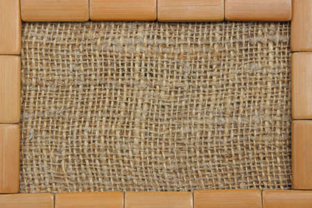 Frame of wooden rectangular boards against the background of lianna fabricの写真素材