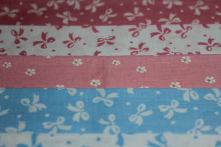 Multicolored cuts of fabric against the background of boards