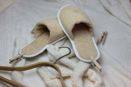 Terry bathrobe and bath slippers with a wooden hanger