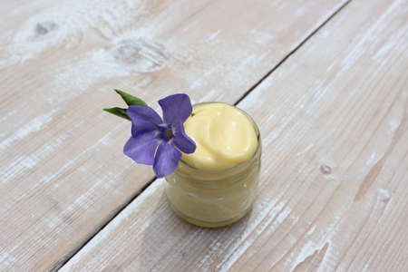 Organic cream for the face with vinca flowerの写真素材