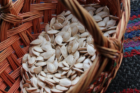 Old wicker wooden basket with pumpkin seedsの写真素材