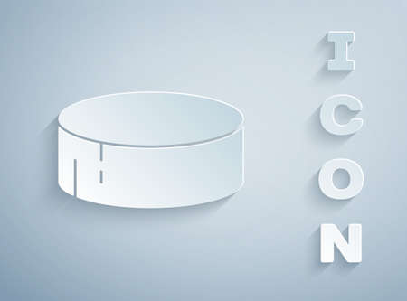 Paper cut Hockey puck icon isolated on grey background. Sport equipment. Paper art style. Vector Illustrationのイラスト素材