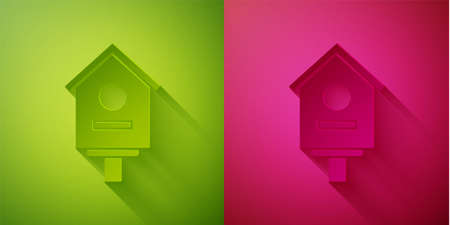 Paper cut Bird house icon isolated on green and pink background. Nesting box birdhouse, homemade building for birds. Paper art style. Vector Illustrationのイラスト素材