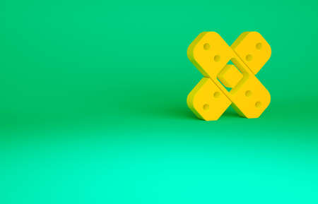 Orange Crossed bandage plaster icon isolated on green background. Medical plaster, adhesive bandage,...