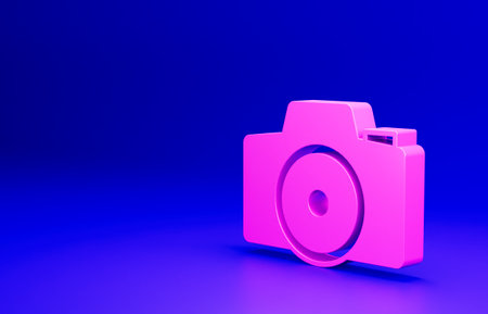 Pink Photo camera icon isolated on blue background. Foto camera. Digital photography. Minimalism concept. 3D render illustrationの写真素材