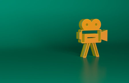 Orange Retro cinema camera icon isolated on green background. Video camera. Movie sign. Film projector. Minimalism concept. 3D render illustrationの写真素材