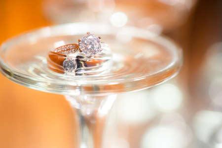 Wedding ring on glassの写真素材