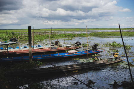 Fishing boat docked on the lake.の写真素材