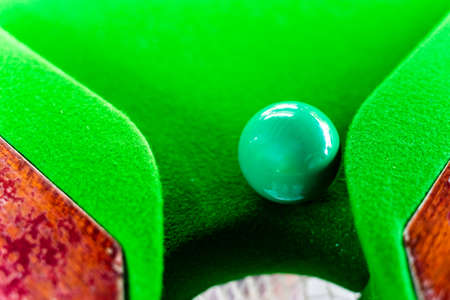 Green snooker balls on the snooker table