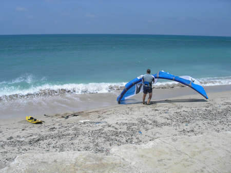 kite surfer on the beach in Israel getting ready to go in the water