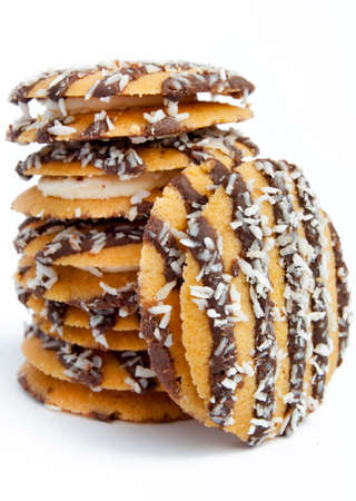 closeup of chocolate covered cookies stacked against a white backgroundの写真素材