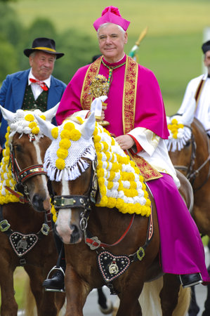 BAD KOETZTING, GERMANY - JUNE 13: bishop Mueller and 950 rider with horses took part at the biggest german annual and 599th religious horse procession -Pfingstritt- at June 13, 2011 in Bad Koetzting, Germanyのeditorial素材