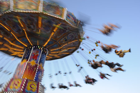 MUNICH, GERMANY - SEPTEMBER 21: carousel with flying people at world biggest beer festival -Oktoberfest in Munich- on September  21, 2011 in Munich, Germanyのeditorial素材