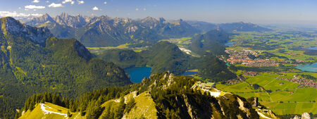 panorama landscape in Bavaria, with lake Alpsee, city Fuessen and alps mountainsの写真素材