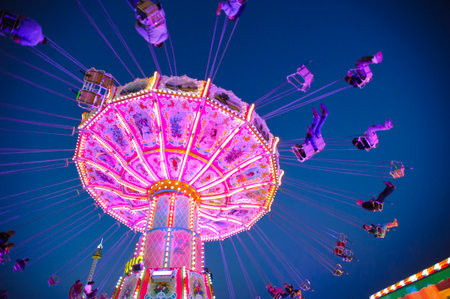 MUNICH, GERMANY - SEPTEMBER 23, 2014: The Oktoberfest in Munich is the biggest beeer festival of the world. The visitors have lot of fun with many amusement huts and carousels.のeditorial素材