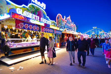 MUNICH, GERMANY - SEPTEMBER 23, 2014: The Oktoberfest in Munich is the biggest beer festival of the world. The visitors have lot of fun with many amusement huts and shops for food, gifts and souvenirs.のeditorial素材